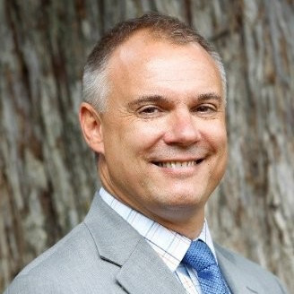 Man in grey suit smiling