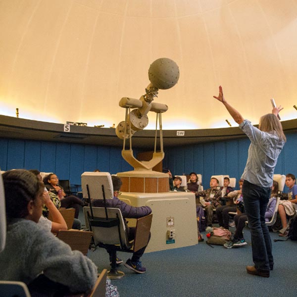 Professor discussing the Planetarium in class