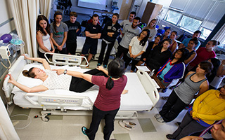 Students seeing a live demonstration from a nurse