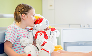 Girl holding little robot