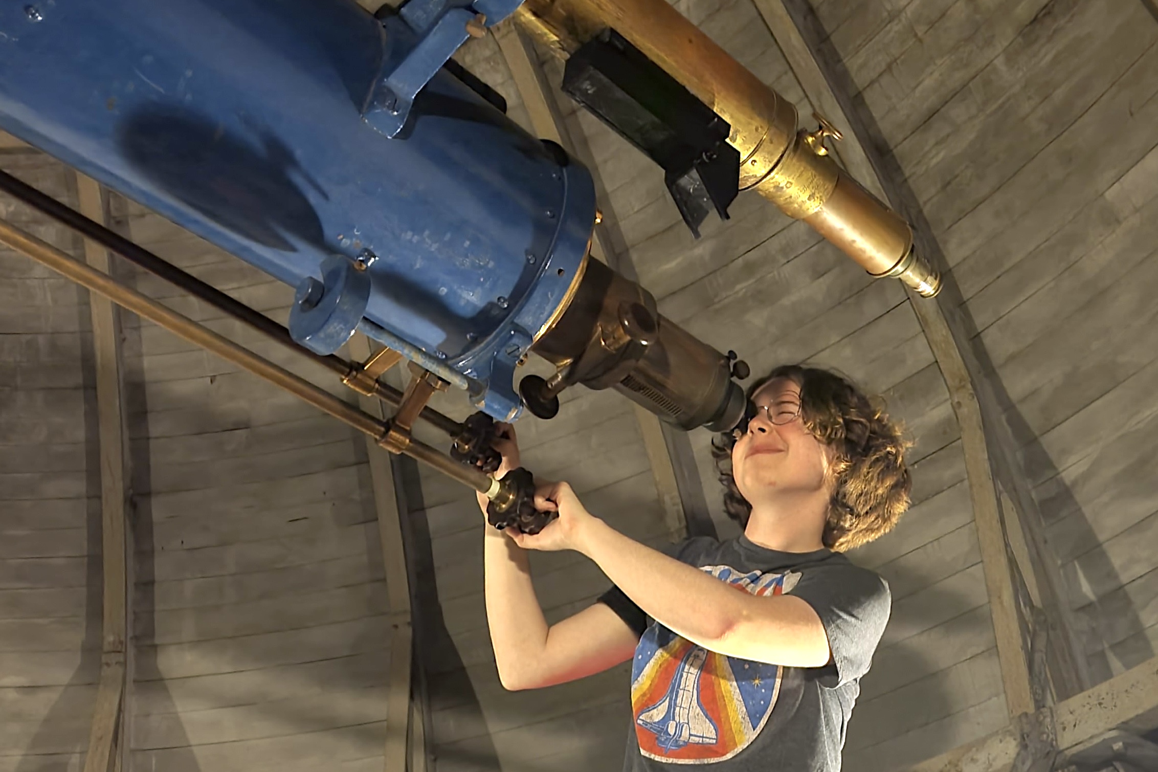 Gillis Lowry peering through a telescope