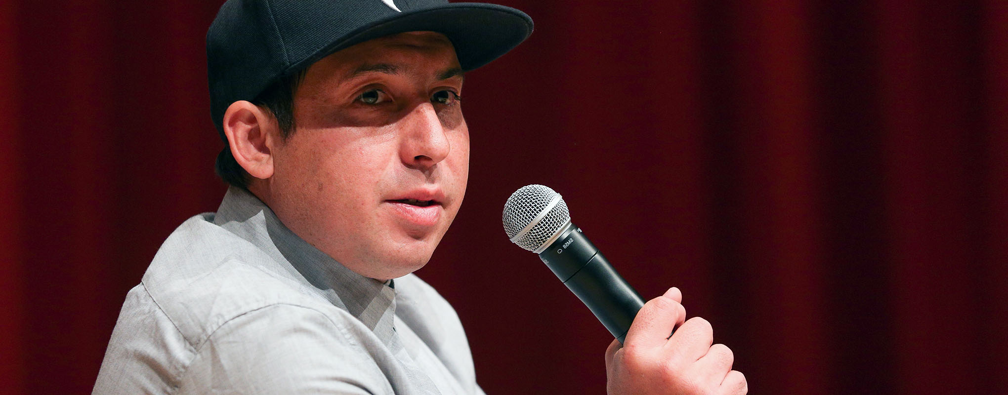 Novelist Tommy Orange with microphone