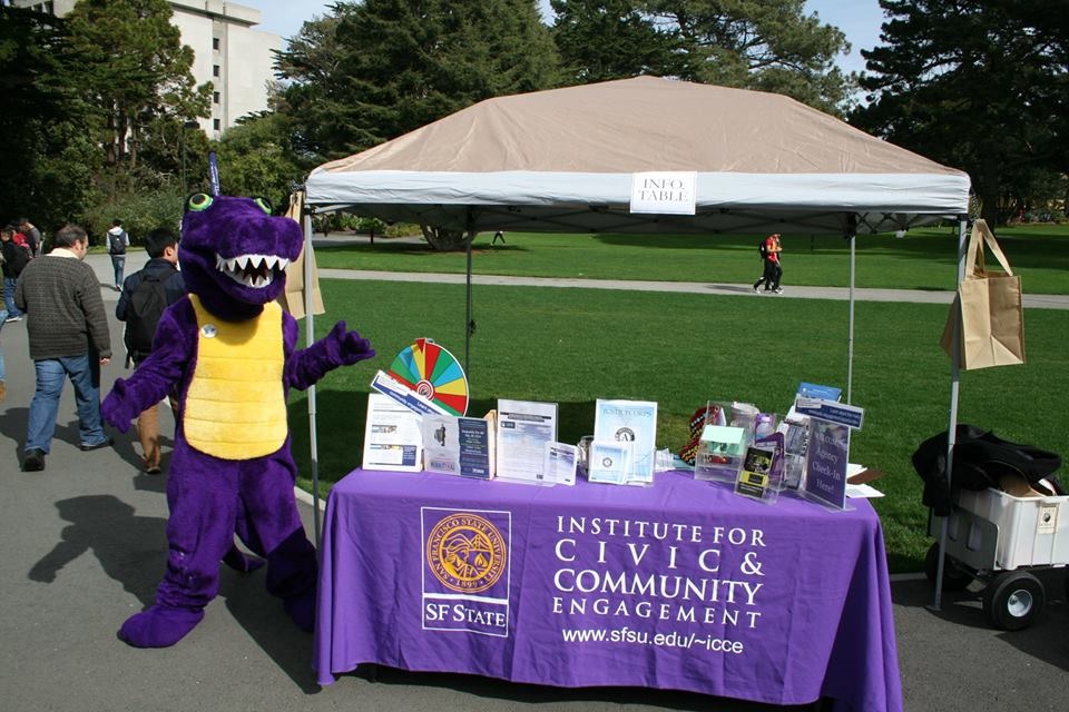 Mascot in front of some stands