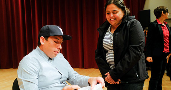 Tommy Orange signing copies of his book, "There, There"