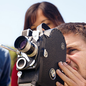 Student looking through a camera lens