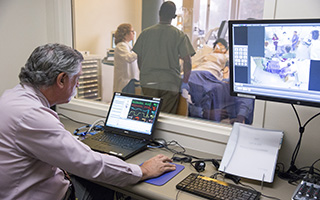 Worker observing nurse and shadowing students