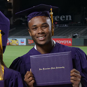 Student holding diploma at commencement