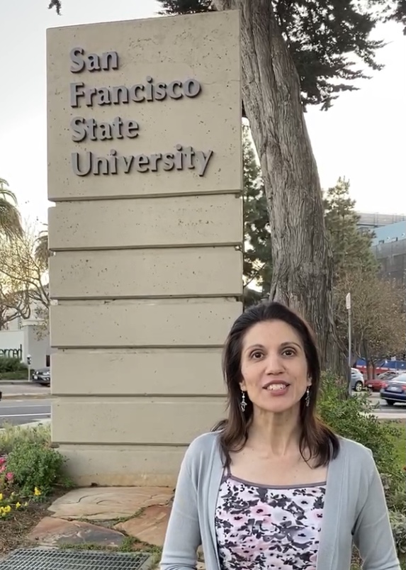 Armaan in front of the SF State sign