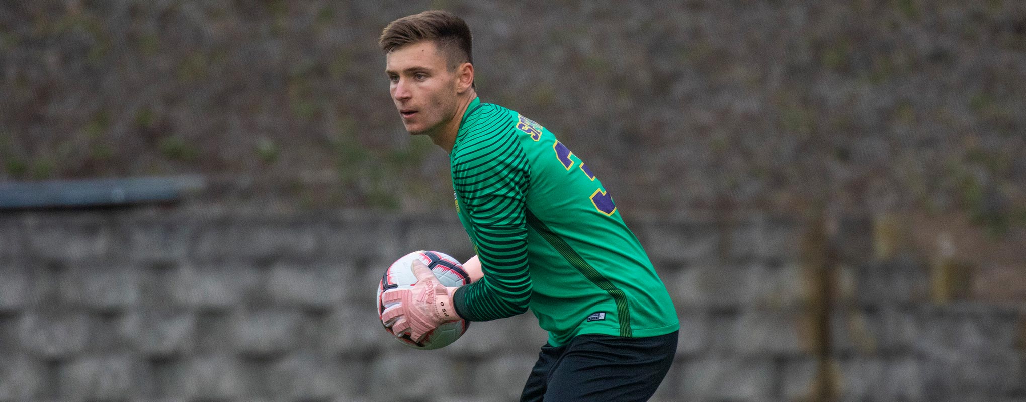 Soccer player Peter Swinkels holding soccer ball