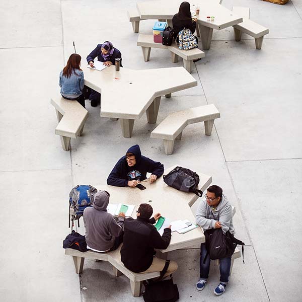 Students sitting in front of the library