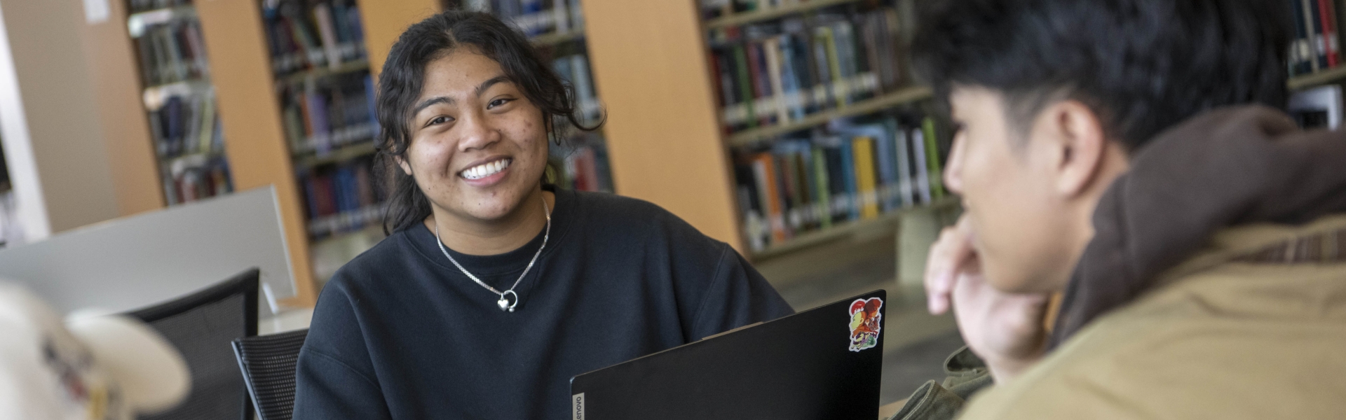 student in library smiling