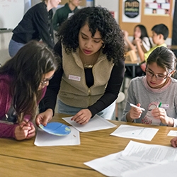 Student teaching younger students.