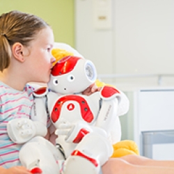 Girl holding little robot