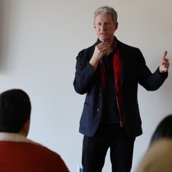 Man in suit giving a lecture