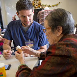 Student nurse working with elderly person