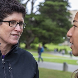 President Lynn conversing with a student