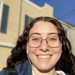 young woman with glasses smiling