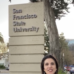 Armaan in front of the SF State sign