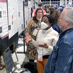Uzor explaining at a conference