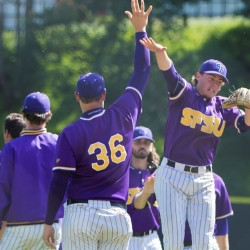 Student athletes high five-ing each other