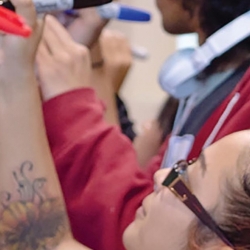 students writing on whiteboard