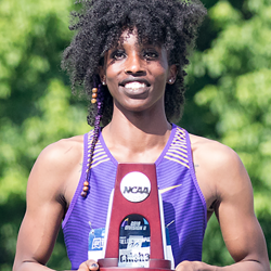 Monisha holding an award