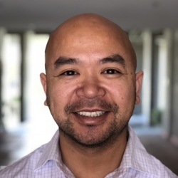 headshot of a man smiling